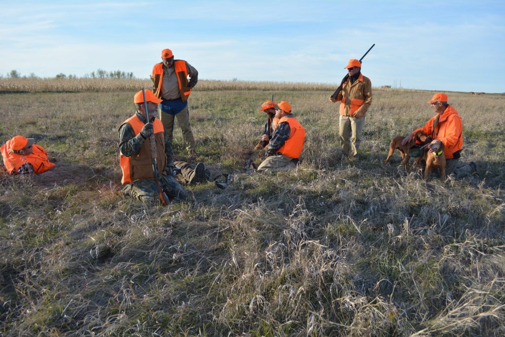 hunters with pheasant catch