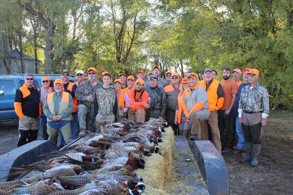 hunters with pheasant catch